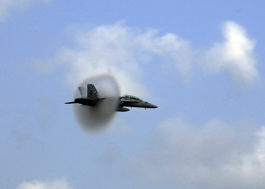 7. An F/A-18F Super Hornet Fighter Jet Assigned to the 'Checkmates' of Strike Fighter Squadron Two One One (VFA-211), 2005 Naval Air Station Oceana Air Show, Naval Air Station Oceana, September 18, 2005, Virginia Beach, Commonwealth of Virginia, USA. Flying at transonic speeds (flying transonically) -- speeds varying near and at the speed of sound (supersonic) -- can generate impressive condensation clouds caused by the Prandtl-Glauert Singularity. For a scientific explanation, see Professor M. S. Cramer's Gallery of Fluid Mechanics, Prandtl-Glauert Singularity at <http://www.GalleryOfFluidMechanics.com/conden/pg_sing.htm>; and Foundations of Fluid Mechanics, Navier-Stokes Equations Potential Flows: Prandtl-Glauert Similarity Laws at <http://www.Navier-Stokes.net/nspfsim.htm>. Photo Credit: Photographer's Mate 3rd Class Layla Pritchett, Navy NewsStand - Eye on the Fleet Photo Gallery (http://www.news.navy.mil/view_photos.asp, 050918-N-2328P-382), United States Navy (USN, http://www.navy.mil), United States Department of Defense (DoD, http://www.DefenseLink.mil or http://www.dod.gov), Government of the United States of America (USA).