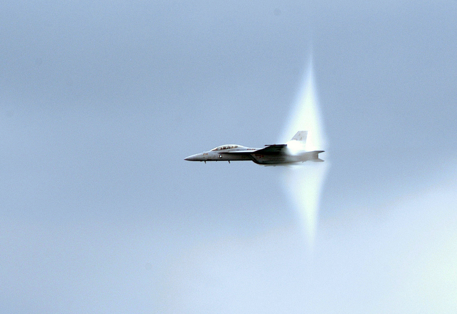 14. 47th Annual Chicago Air and Water Show at North Avenue Beach, August 20, 2005: A United States Navy F/A-18F Super Hornet Fighter Jet, assigned to the 'Gladiators' of Strike Fighter Squadron One Zero Six (VFA-106), Flying Over Lake Michigan With Its Prandtl-Glauert Cloud. Chicago, State of Illinois, USA. Reaching the sound barrier, breaking the sound barrier: Flying at transonic speeds (flying transonically) -- speeds varying near and at the speed of sound (supersonic) -- can generate impressive condensation clouds caused by the Prandtl-Glauert Singularity. For a scientific explanation, see Professor M. S. Cramer's Gallery of Fluid Mechanics, Prandtl-Glauert Singularity at <http://www.GalleryOfFluidMechanics.com/conden/pg_sing.htm>; and Foundations of Fluid Mechanics, Navier-Stokes Equations Potential Flows: Prandtl-Glauert Similarity Laws at <http://www.Navier-Stokes.net/nspfsim.htm>. Photo Credit: Photographer's Mate 1st Class Steve Schmidt, Navy NewsStand - Eye on the Fleet Photo Gallery (http://www.news.navy.mil/view_photos.asp, 050820-N-6727S-505), United States Navy (USN, http://www.navy.mil), United States Department of Defense (DoD, http://www.DefenseLink.mil or http://www.dod.gov), Government of the United States of America (USA).