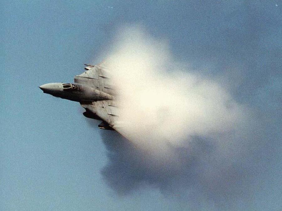 13. An F/A-18C Hornet Fighter Jet Assigned to the 'Golden Dragons' of Strike Fighter Squadron One Nine Two (VFA-192). August 17, 2005, Pacific Ocean. Reaching the sound barrier, breaking the sound barrier: Flying at transonic speeds (flying transonically) -- speeds varying near and at the speed of sound (supersonic) -- can generate impressive condensation clouds caused by the Prandtl-Glauert Singularity. For a scientific explanation, see Professor M. S. Cramer's Gallery of Fluid Mechanics, Prandtl-Glauert Singularity at <http://www.GalleryOfFluidMechanics.com/conden/pg_sing.htm>; and Foundations of Fluid Mechanics, Navier-Stokes Equations Potential Flows: Prandtl-Glauert Similarity Laws at <http://www.Navier-Stokes.net/nspfsim.htm>. Photo Credit: Photographer's Mate 3rd Class Jonathan Chandler, Navy NewsStand - Eye on the Fleet Photo Gallery (http://www.news.navy.mil/view_photos.asp, 050817-N-3488C-151), United States Navy (USN, http://www.navy.mil), United States Department of Defense (DoD, http://www.DefenseLink.mil or http://www.dod.gov), Government of the United States of America (USA). See the companion photo in 'An F/A-18C Hornet conducts a high-speed pass prior to breaking the speed of sound.' at <http://www.news.navy.mil/view_single.asp?id=27228>.