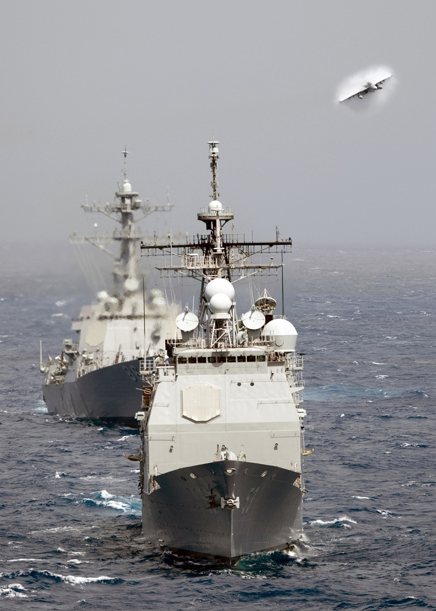 13. A Transonic F/A-18E Super Hornet Assigned to the 'Bounty Hunters' of Strike Fighter Squadron 2 (VFA-2) Performs a High-Speed Flyby Above the Ticonderoga-class Guided-missile Cruiser USS Mobile Bay (CG 53) and the  Arleigh Burke-class Guided-missile Destroyer USS Shoup (DDG 86), April 22, 2008, Indian Ocean. Photo Credit: Mass Communication Specialist 3rd Class Justin R. Blake, Navy NewsStand - Eye on the Fleet Photo Gallery (http://www.news.navy.mil/view_photos.asp, 080422-N-5384B-116), United States Navy (USN, http://www.navy.mil), United States Department of Defense (DoD, http://www.DefenseLink.mil or http://www.dod.gov), Government of the United States of America (USA).