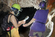 Penny Boston and Diana Northup taking a
                          pH or ORP measurement in the Ragu passage